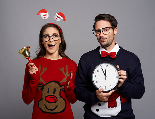 Playful couple announcing the Christmas time