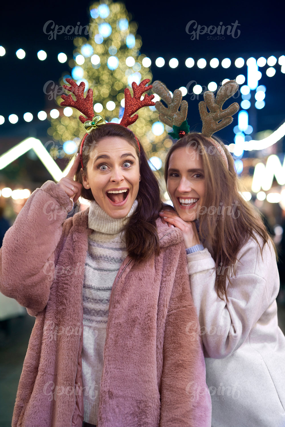 Funny portrait of friends wearing deer hairband