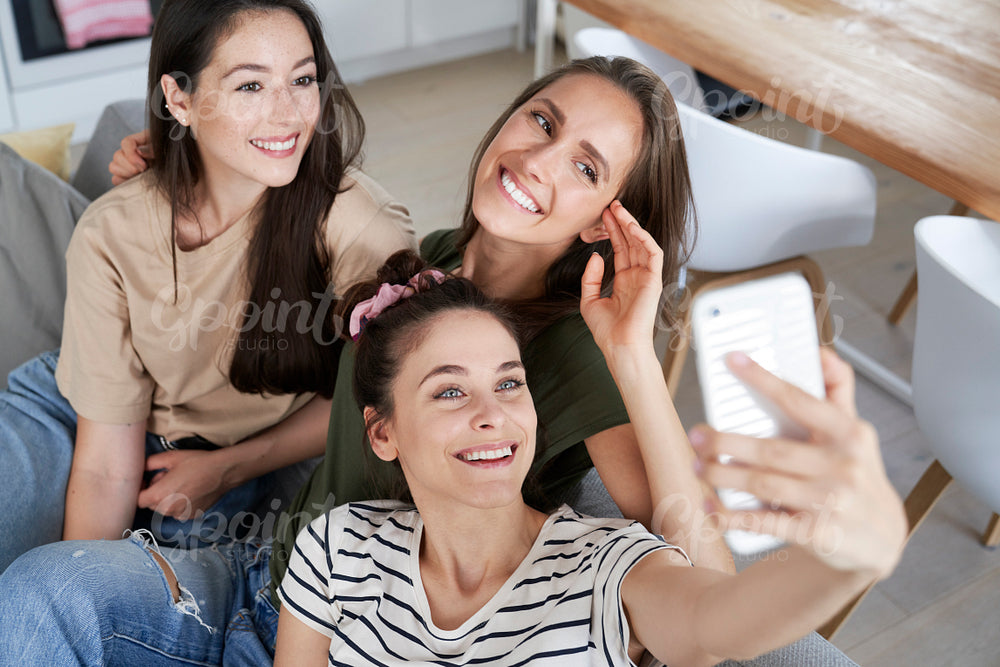 Top view of three best friends taking selfie