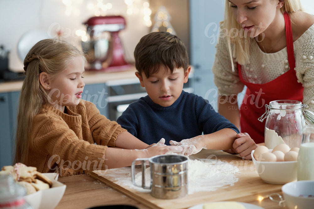 Children preparing pastry for Christmas cookies