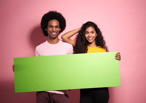 Portrait of African man and woman with green screen.