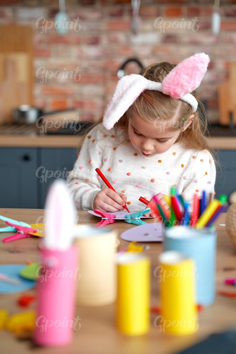 Vertical image of girl painting by colorful pencil at home