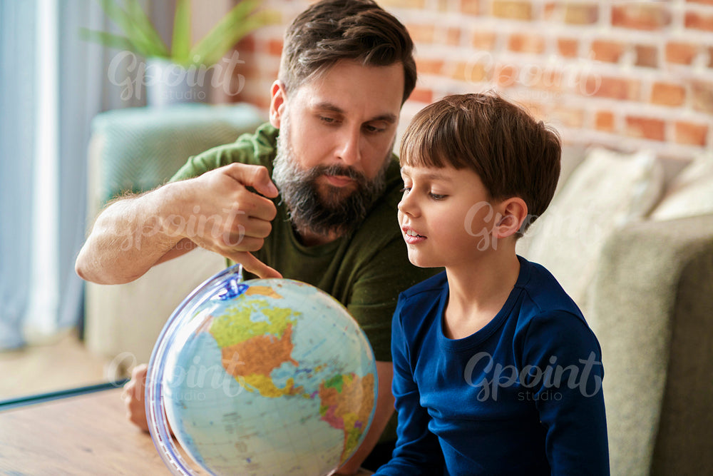 Father and son looking for a travel plan