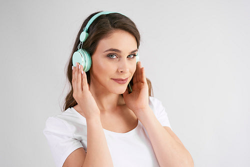 Portrait of young woman with headphones listening to music