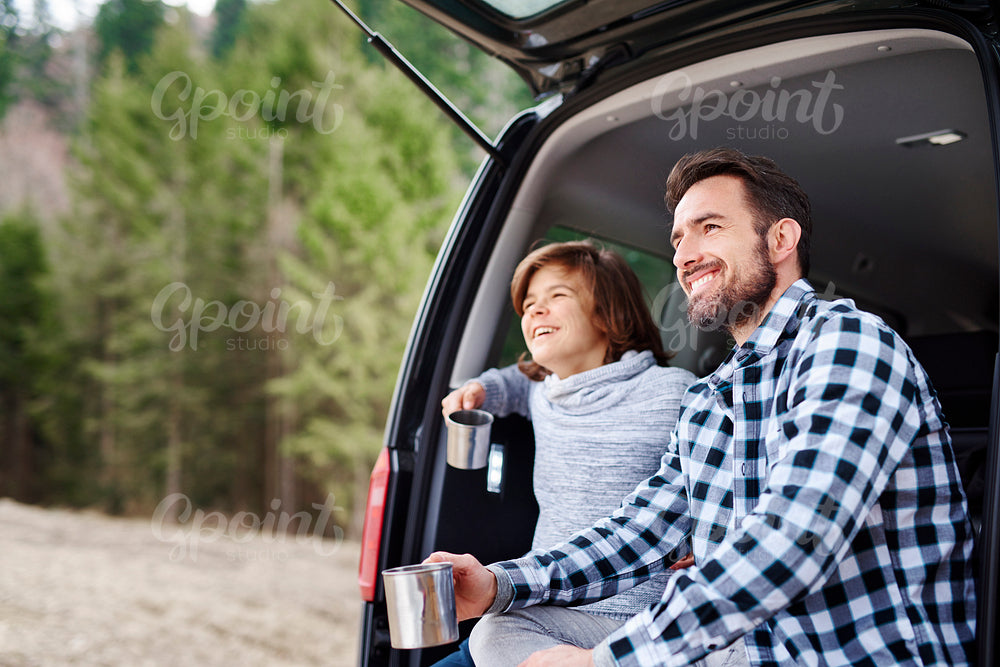 Man and his son enjoying the view during road trip