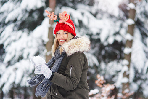 Joyful woman having fun with snow