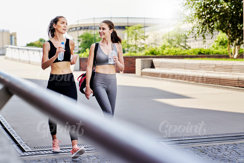 Two athletic women talking on the way to training