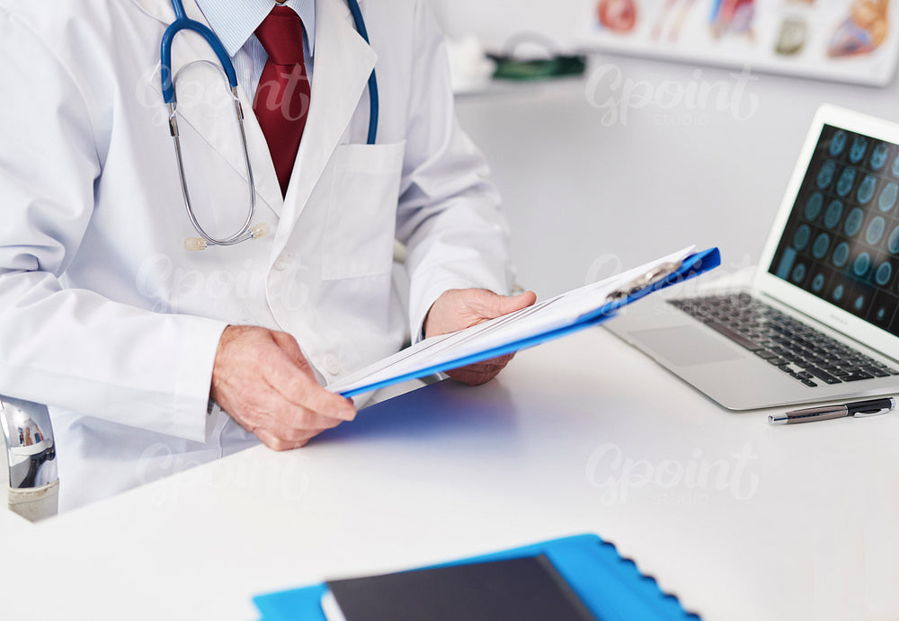 Close up of doctor examining the medical record