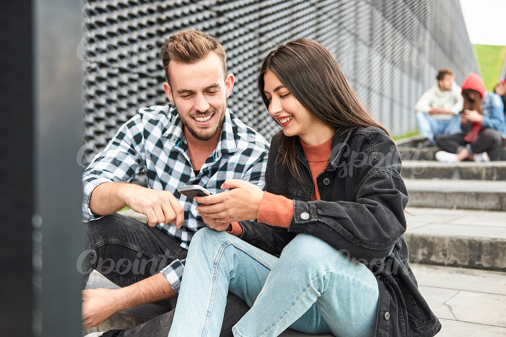 Young couple browsing mobile phone together
