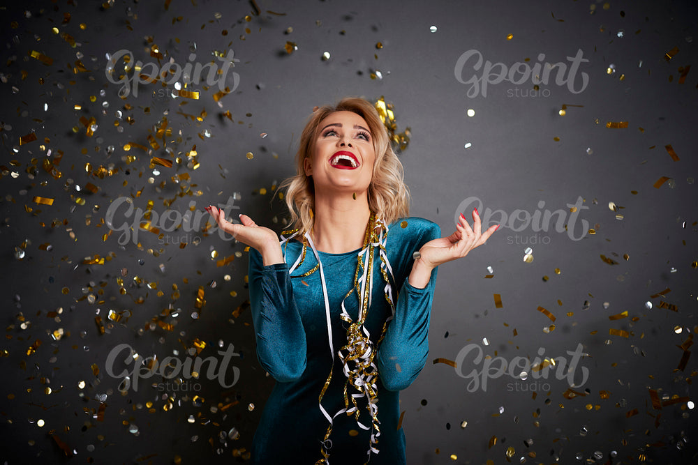 Screaming woman under shower of confetti