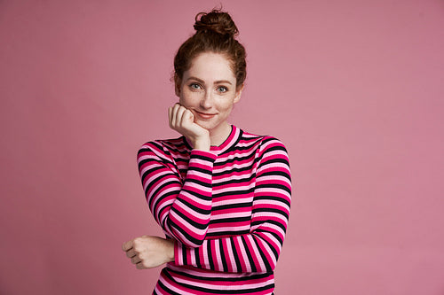 Studio shot of smiling young girl on the pink background