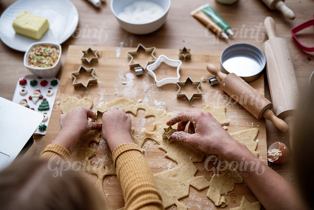 Top view of hands preparing Christmas cookies