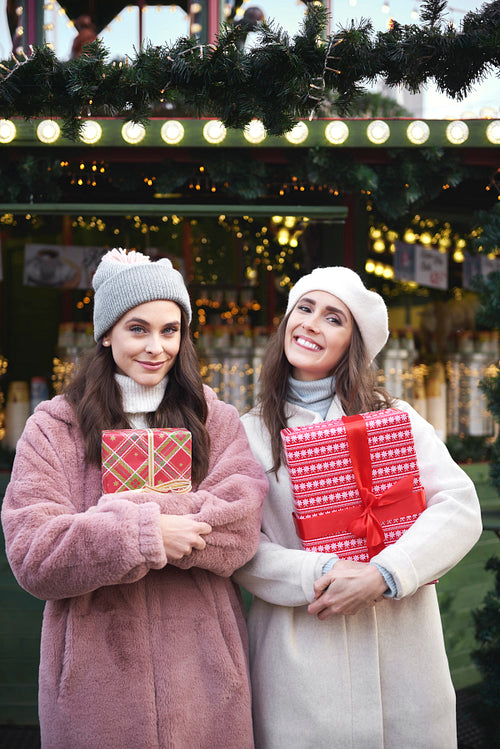 Portrait of two women with presents on Christmas Market