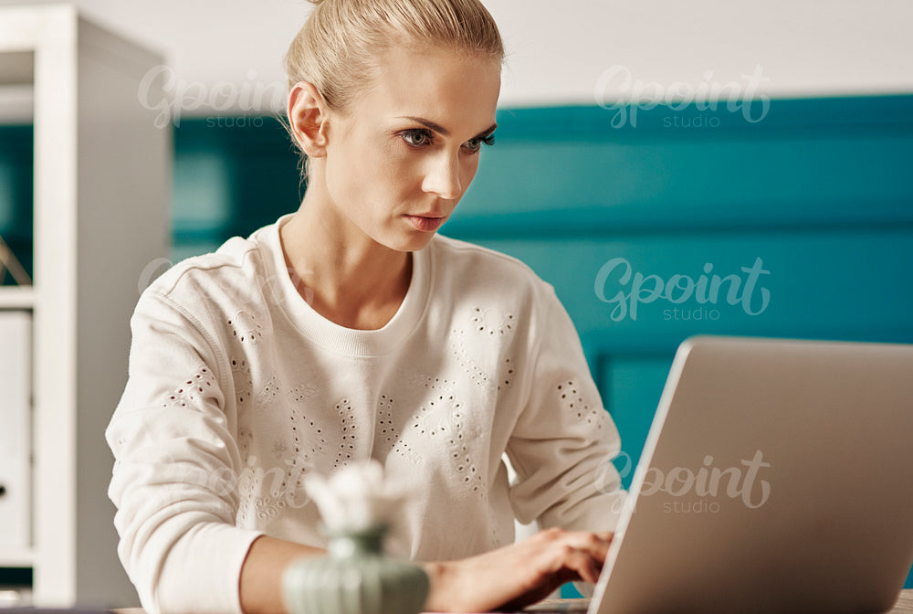 Hard-working woman using laptop at office