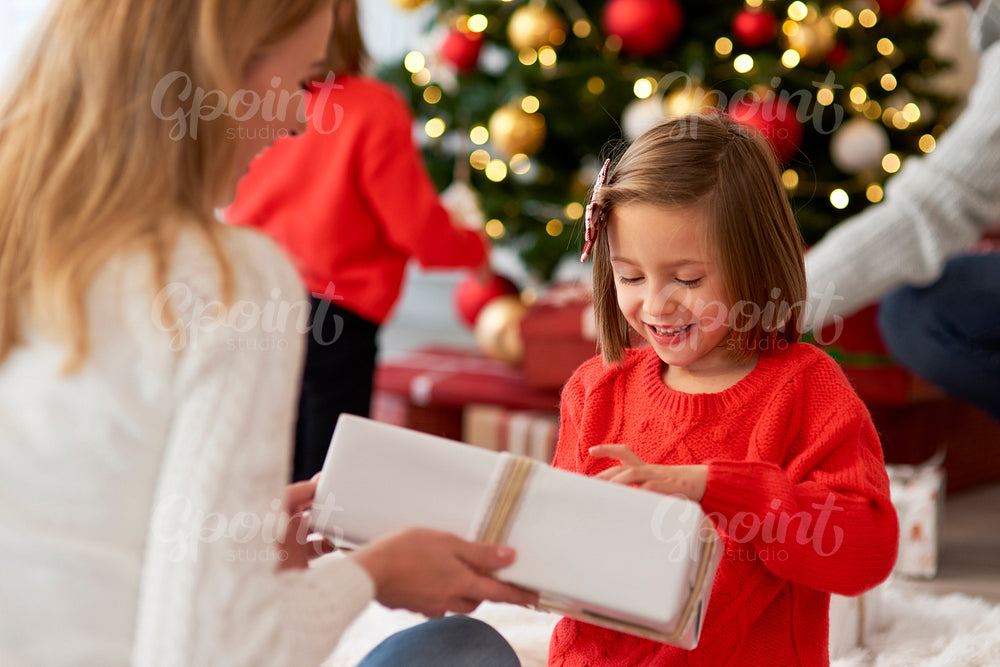 Family starting Christmas from opening presents