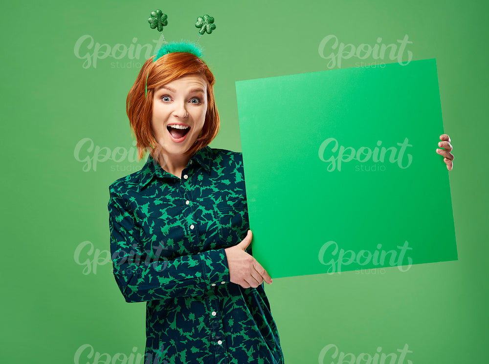 Portrait of screaming woman holding green banner with copy space