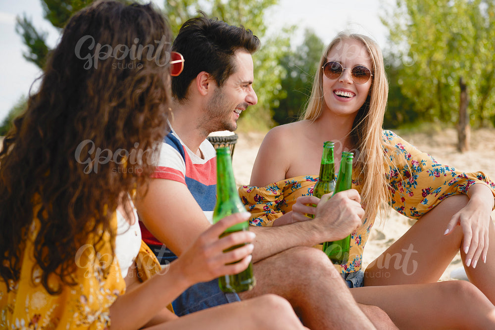 Group of friends spending nice time with beer bottles