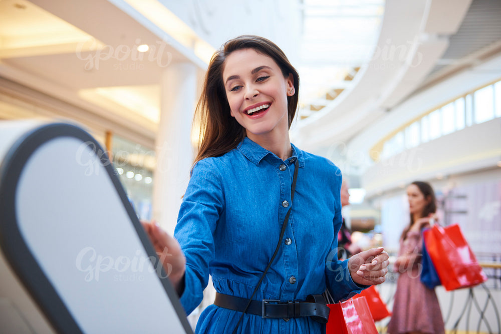 Joyful woman in shopping mall