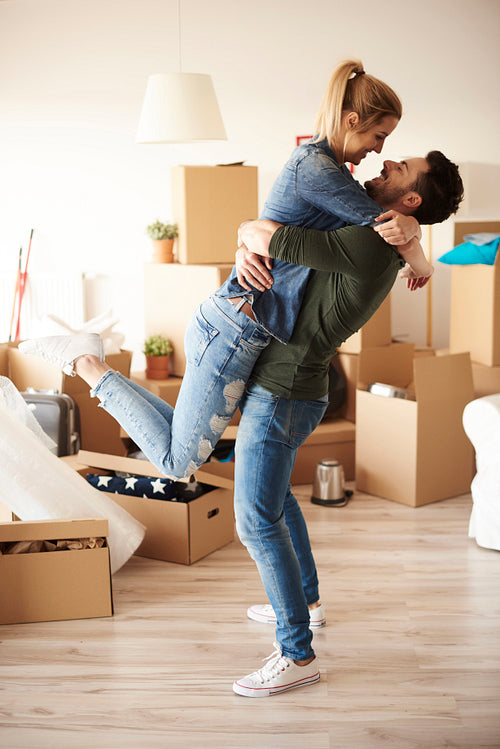 Lucky couple embracing in new house