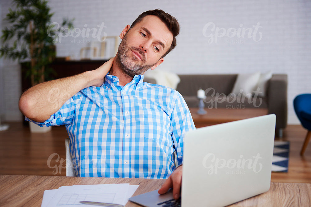 Mature entrepreneur suffering from neck pain