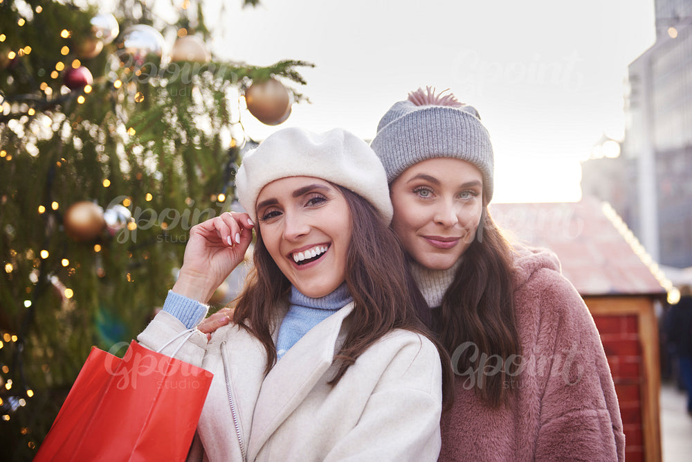Portrait of two women in warm clothes on Christmas market