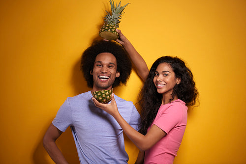 Cheerful couple and tasty pineapple