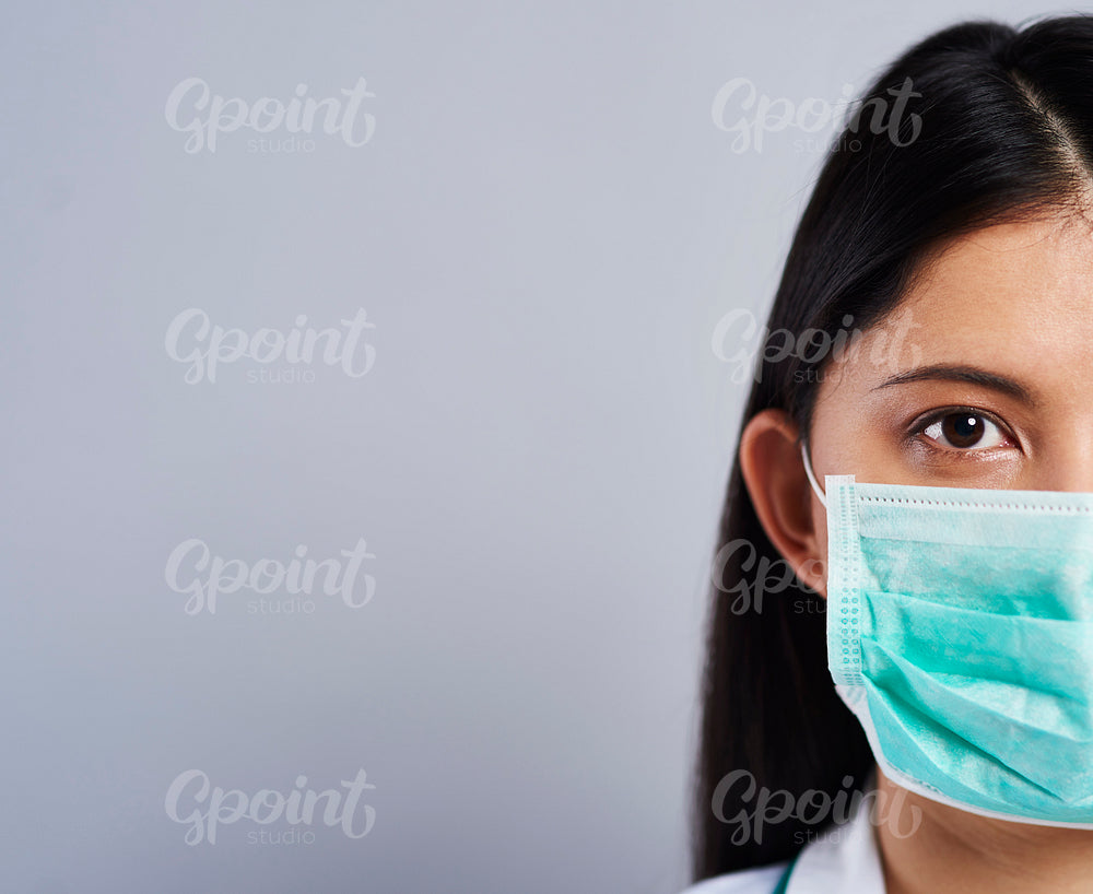 Half face of Asian female doctor