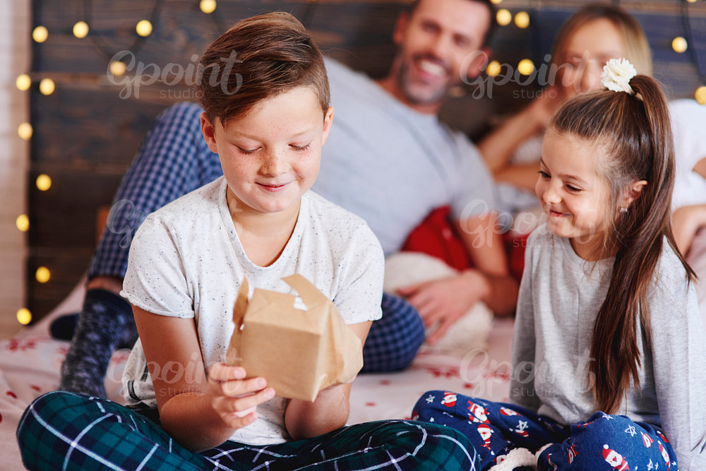 Happy children opening Christmas presents