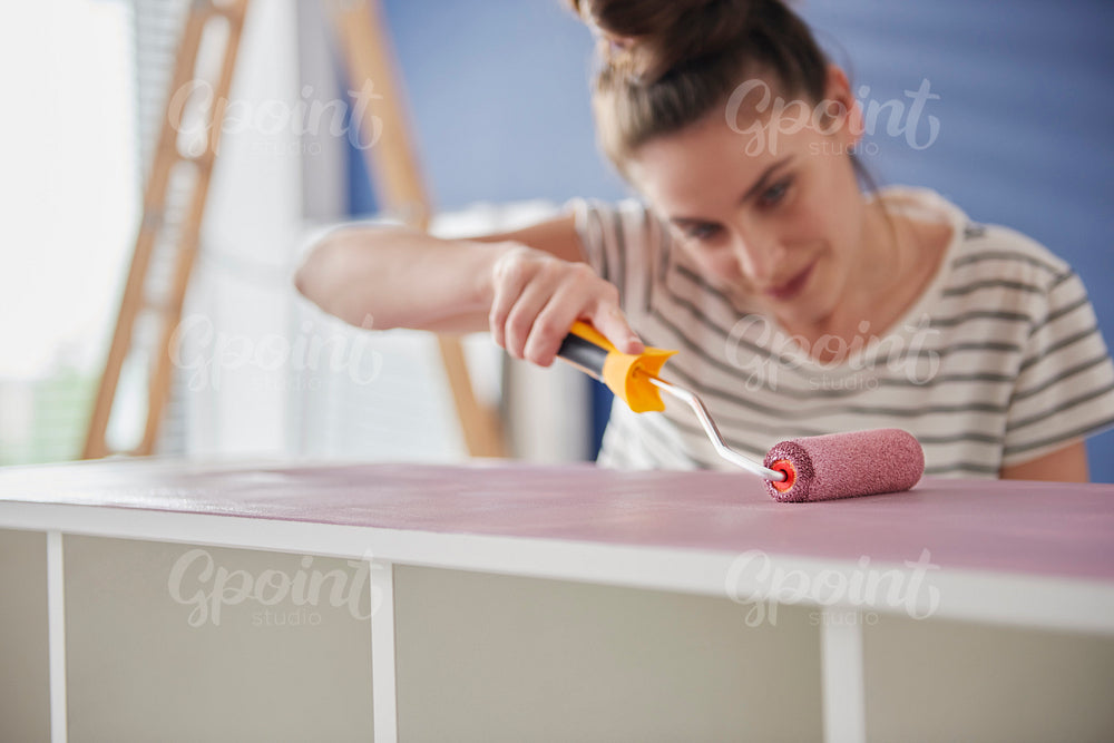 Focus woman painting old furnitures by herself