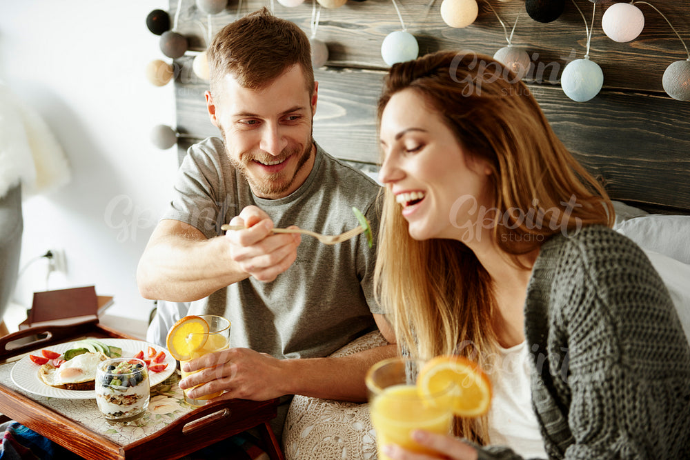 Man sharing breakfast with woman
