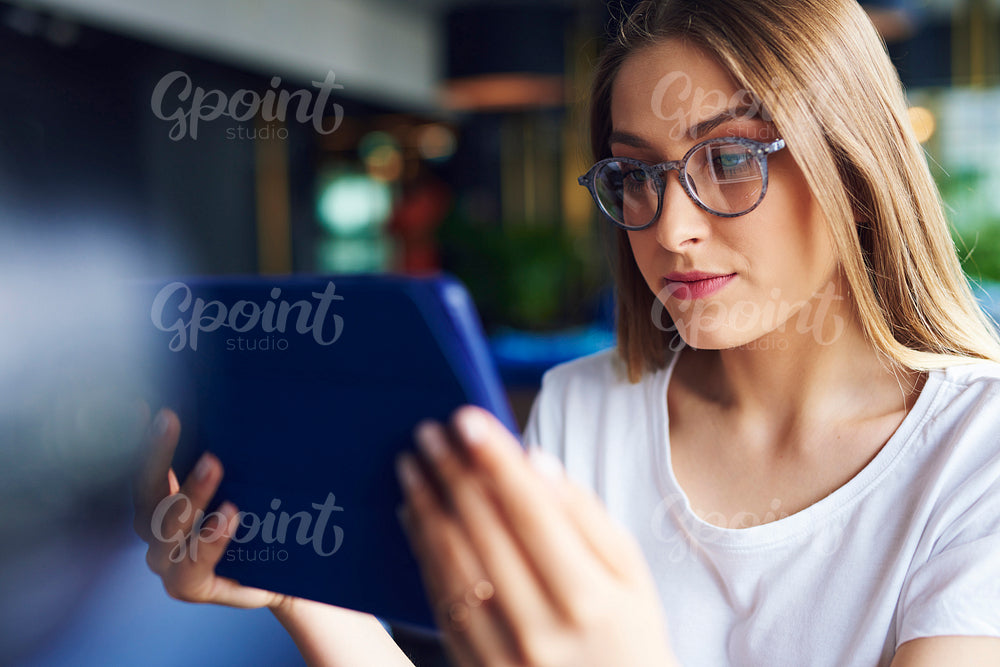Focused woman using a tablet in the office