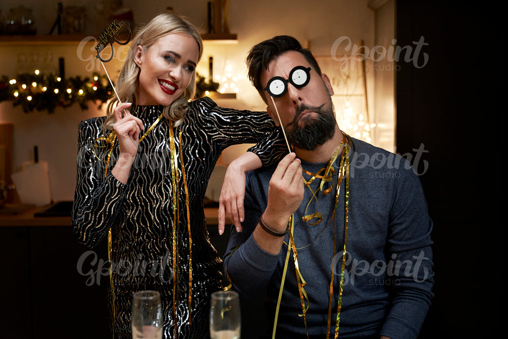 Couple have fun during New Years Eve with a photo booths