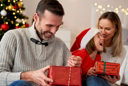Happy family opening gifts at Christmas