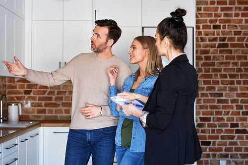 Couple with real estate agent viewing a new apartment