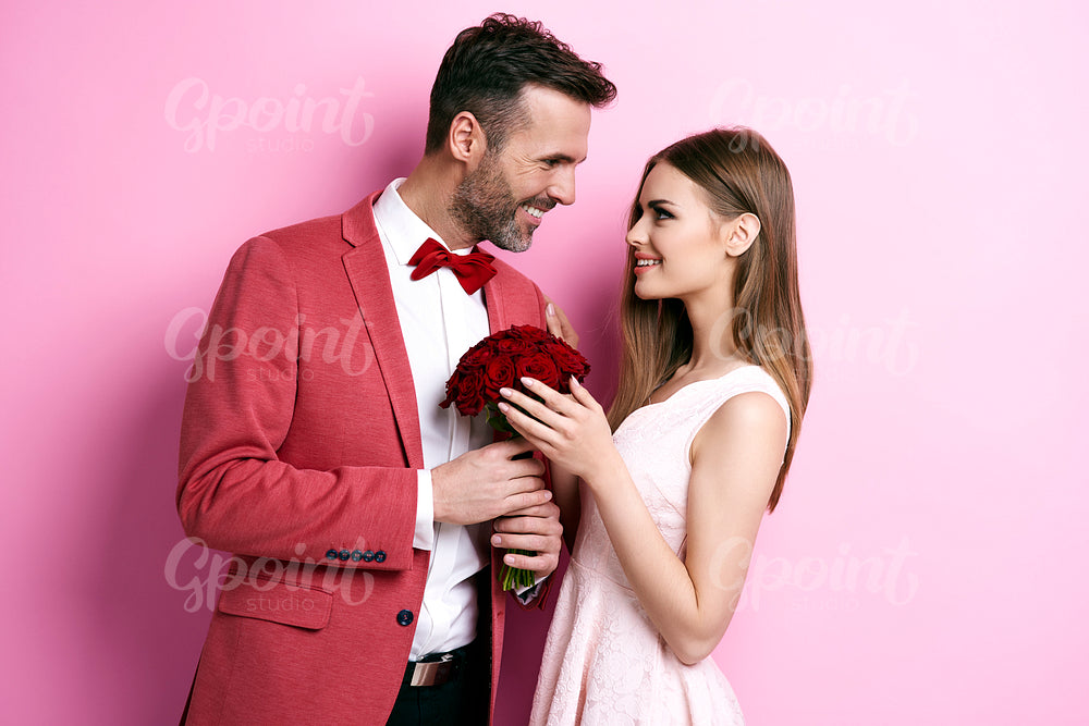 Enamored man with bunch of rose flirting