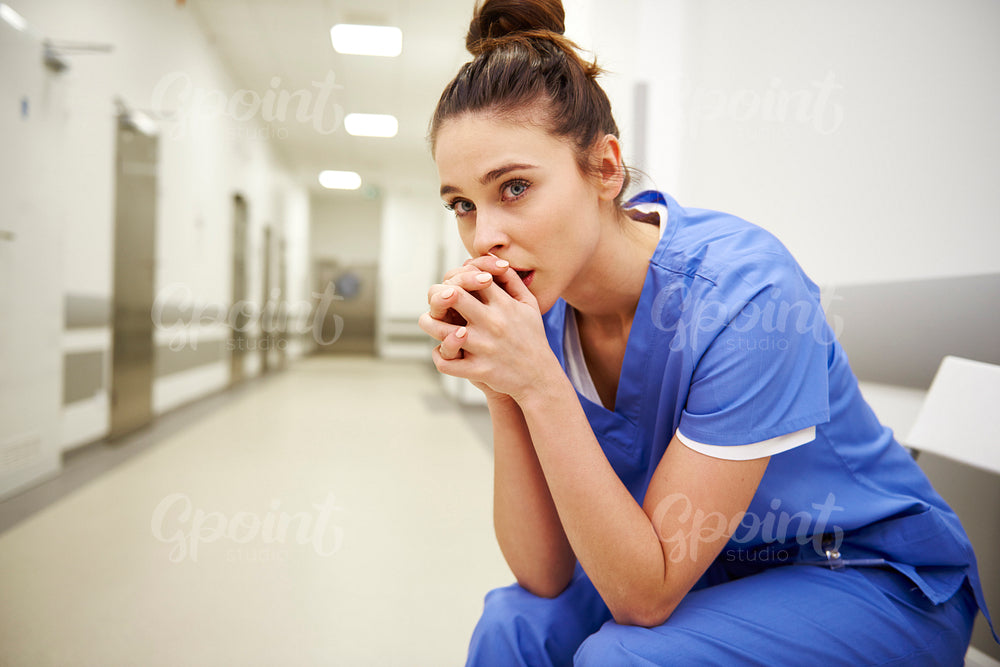 Close up of upset female nurse in the corridor