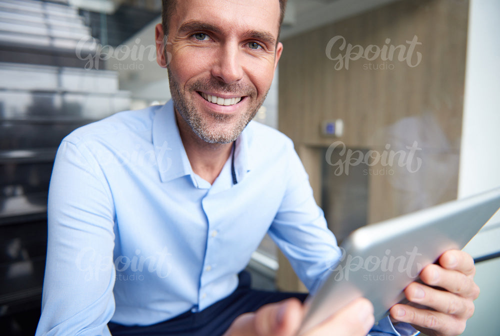 Portrait of businessman with a digital tablet