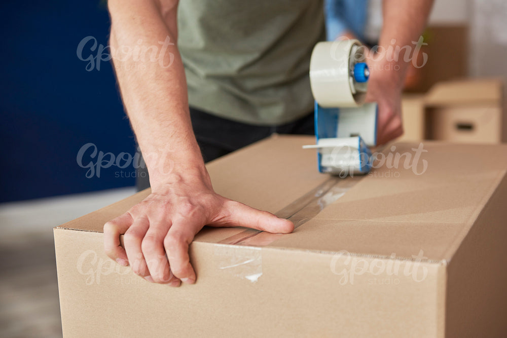 Detail of packing cardboard boxes while moving house