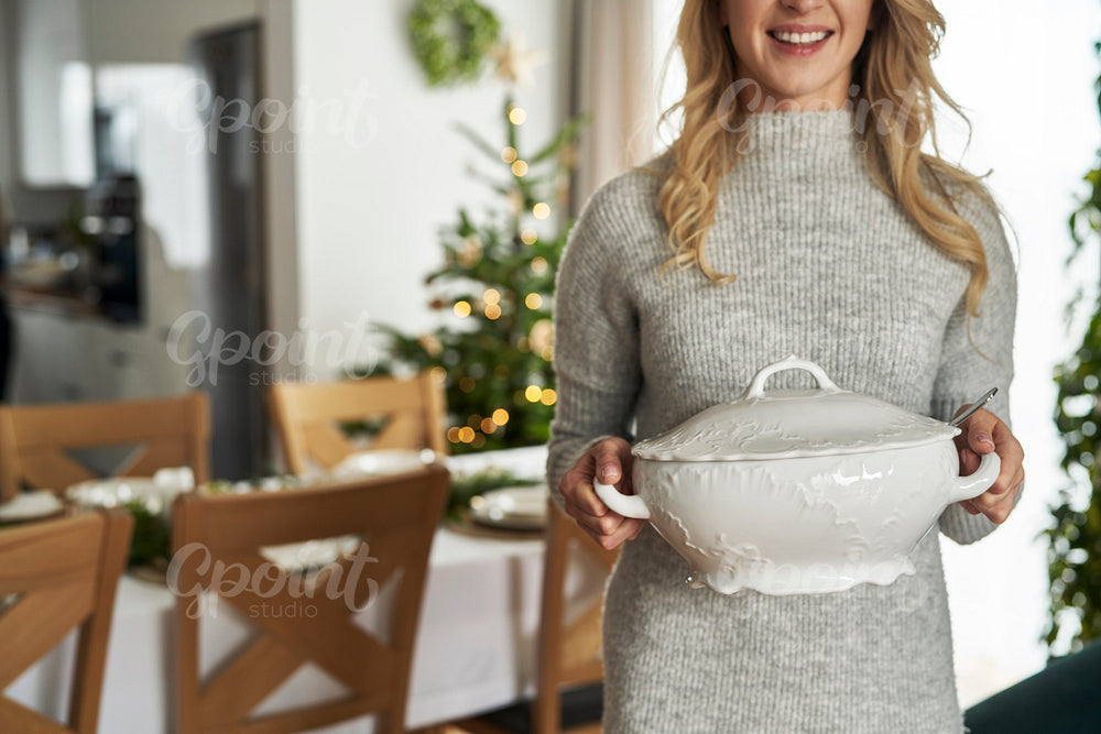 Unrecognizable caucasian woman holding the soup vase 
