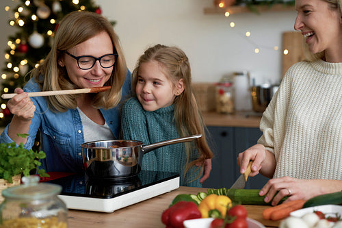 Three women in kitchen preparing Christmas food
