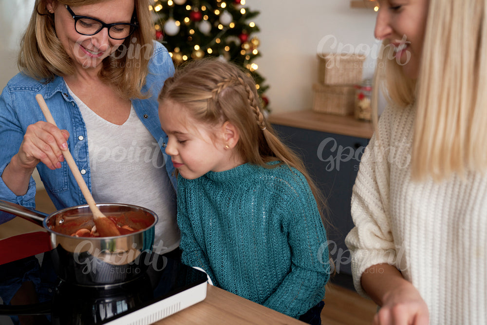 Little girl in the kitchen with her mother and grandma