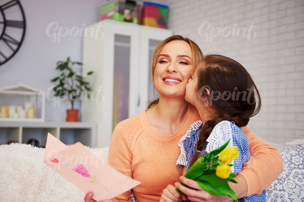 Shot of child kissing her mommy on the cheek