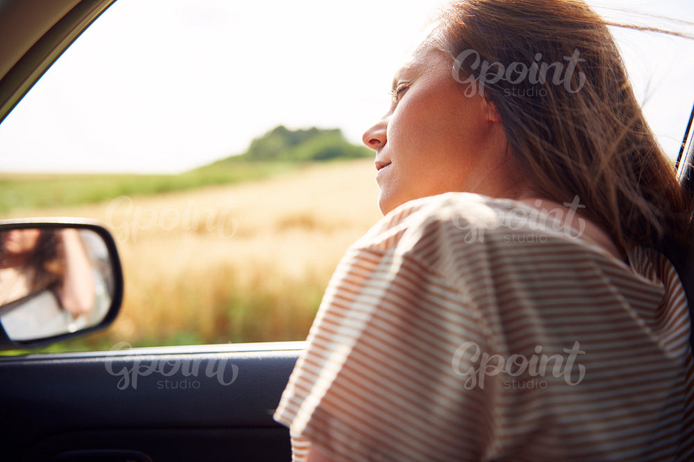 Young woman sleeping during road trip