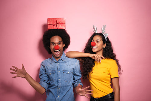 Young African couple with red noses have fun.