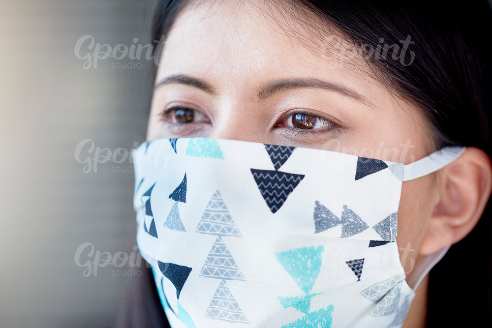 Close up of Asian woman in face mask
