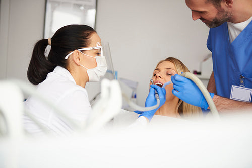 Female dentist working with dental equipment