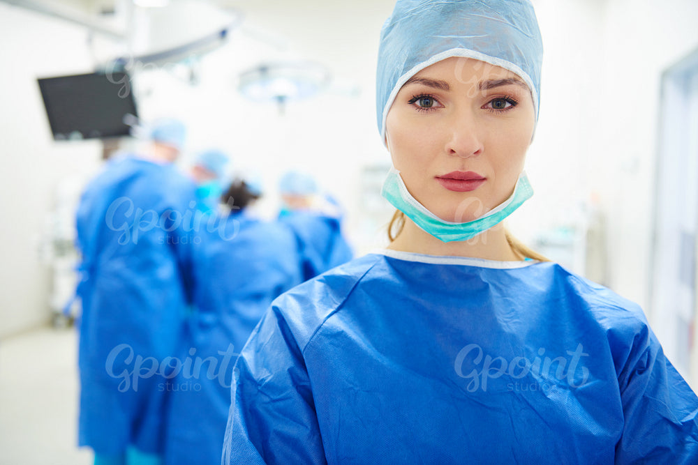 Portrait of female doctor over operation