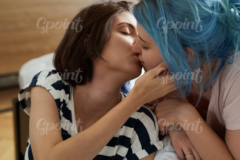 Romantic lesbian couple kissing intimately