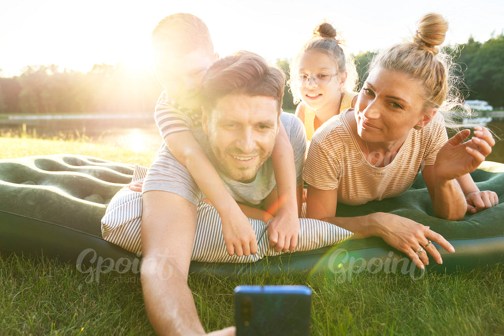 Family taking a selfie while holiday by the lake