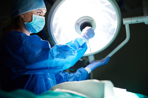 Doctor setting the surgical light